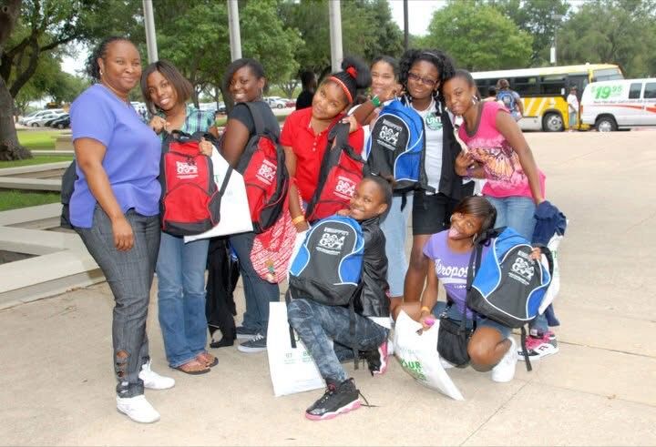 Teens with their new backpacks at a Keepin’ It Real! Youth Empowerment Summit